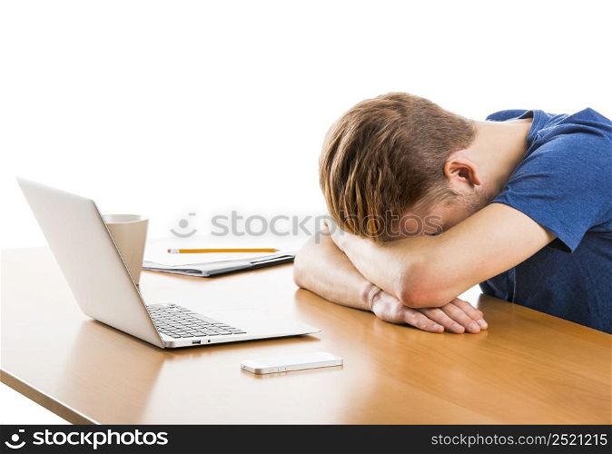 Young man in the office sleeping at the desk