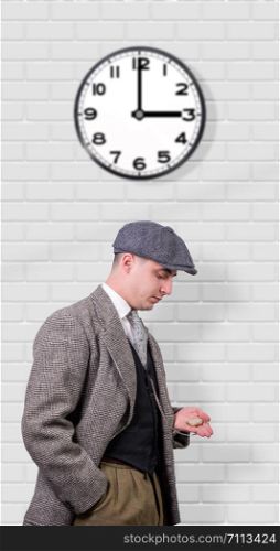 young man in vintage clothes with a hat, looking watch, 1940