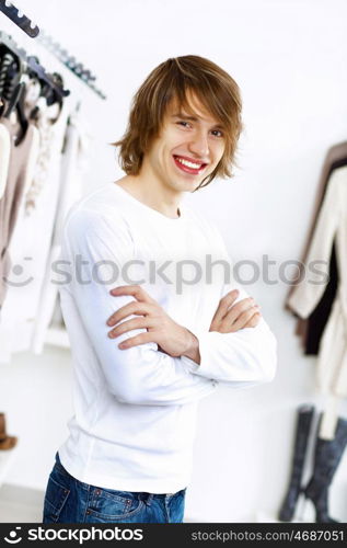 Young man in white sweater doing shopping