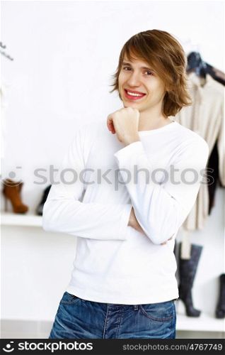 Young man in white sweater doing shopping