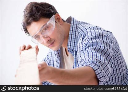 Young man in woodworking hobby concept