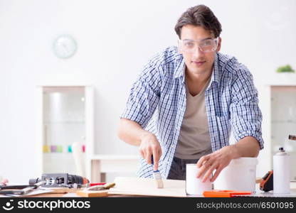 Young man in woodworking hobby concept