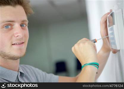 young man installing electronic device
