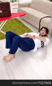 Young man ironing in the bedroom