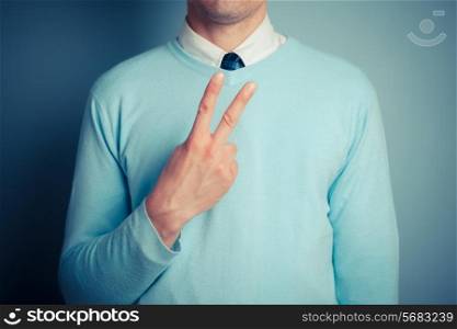 Young man is displaying a rude gesture
