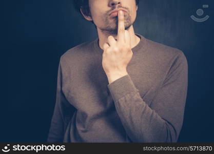 Young man is displaying an obscene gesture