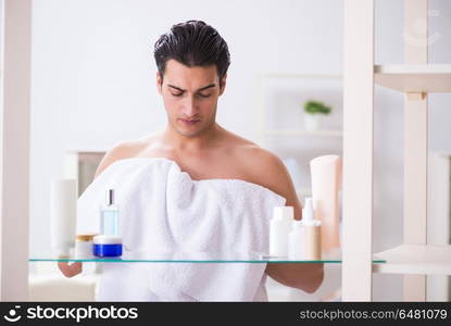 Young man is getting prepared for working day in bathroom