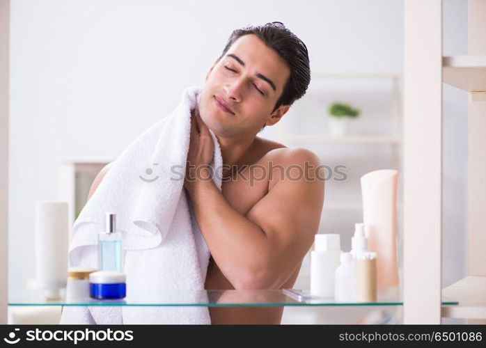 Young man is getting prepared for working day in bathroom