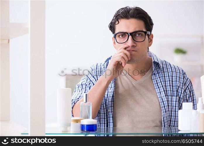 Young man is getting prepared for working day in bathroom