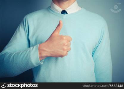 Young man is giving thumbs up