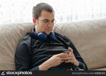 Young man is listening to music at home