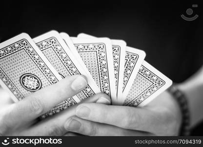 Young man is playing cards, cutout of his hands