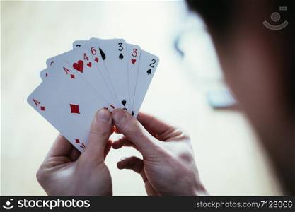 Young man is playing cards, cutout of his hands