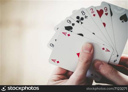Young man is playing cards, cutout of his hands