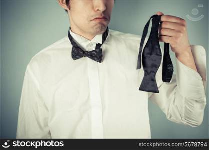 Young man is sad he couldn&rsquo;t tie his own bow tie