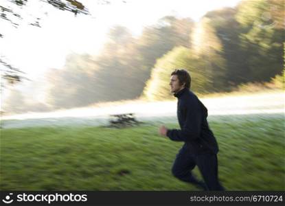 Young man jogging in a park