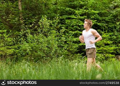 Young man jogging in nature in sportive outfit