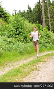 Young man jogging in nature in sportive outfit