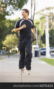 Young Man Jogging On Street