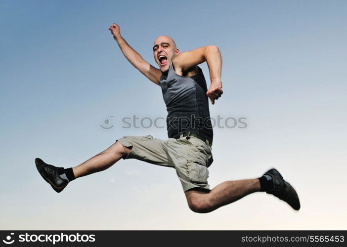 young man jumping in air at sunset outdoor