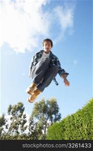 Young Man Jumping On Trampoline Caught In Mid Air