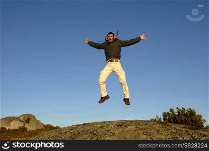 young man jumps high in the mountain