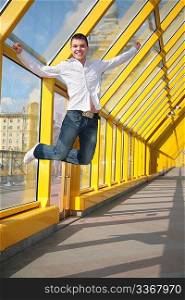 young man jumps on footbridge