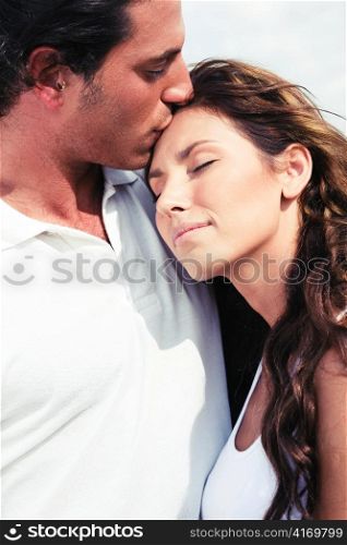 Young man kissing on forehead