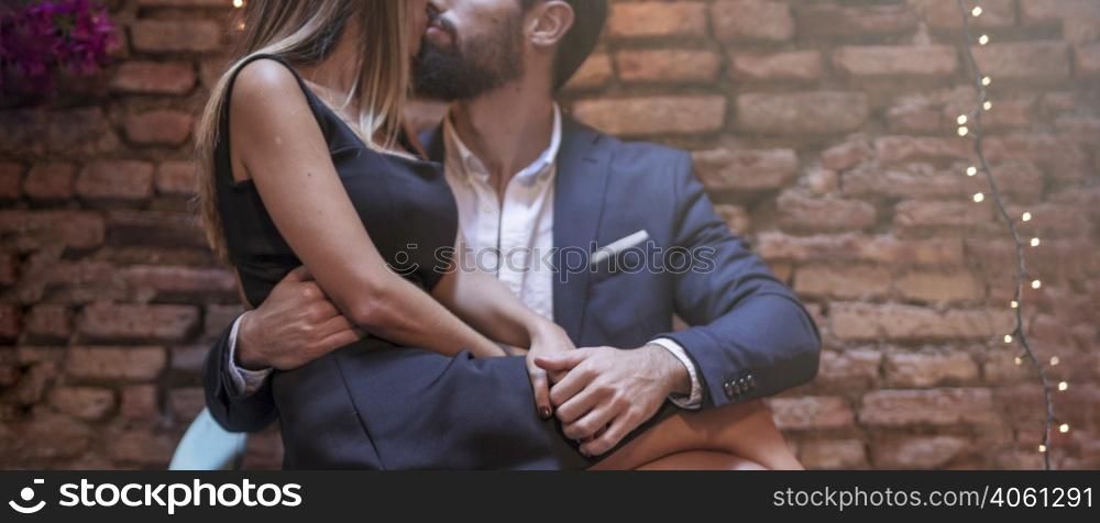 young man kissing with woman chair