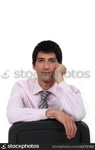 Young man leaning back in chair