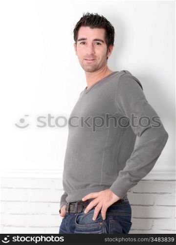 Young man leaning on white background