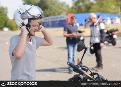young man learning how to ride a motorbike