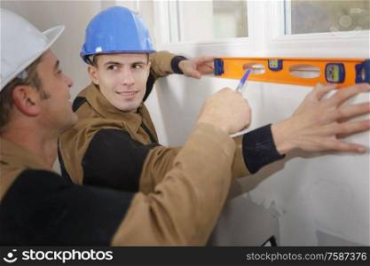 Young man learning to use spirit level