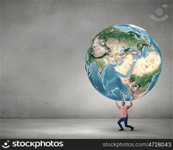 Young man lifting Earth planet above head. Elements of this image are furnished by NASA. Support our planet