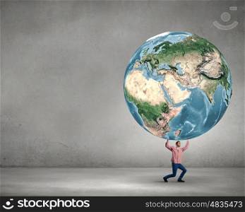 Young man lifting Earth planet above head. Elements of this image are furnished by NASA. Support our planet