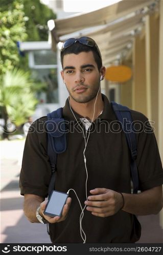 Young man listening to an MP3 player