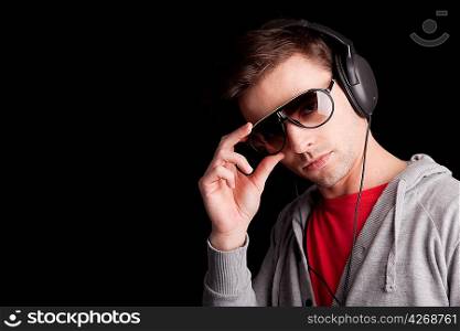 Young man listening to music - isolated