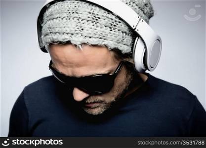 Young man listening to music with white headphones