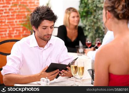 Young man looking at a menu in a restaurant