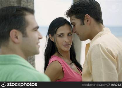 Young man looking at a young couple