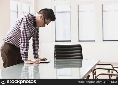 Young man looking at digital tablet on desk