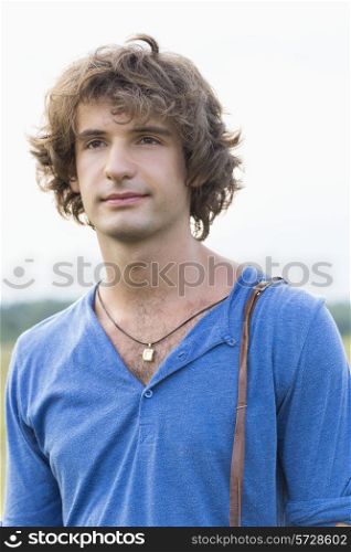 Young man looking away against clear sky