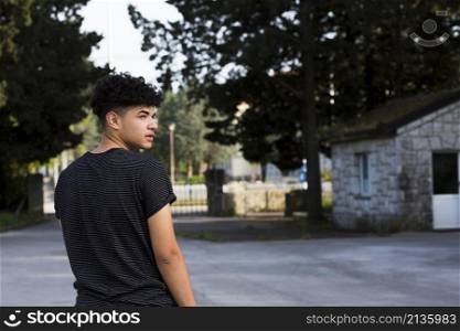 young man looking back urban environment