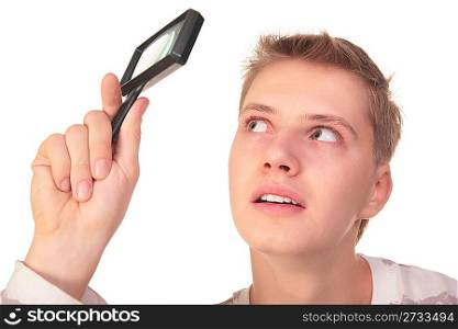 young man looks through magnifier