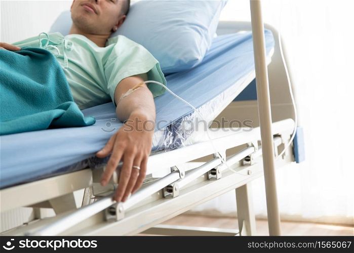 Young Man Lying On Bed At Hospital