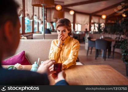 Young man makes marriage proposal to beautiful woman at luxury restaurant. Couple romantic date. Man makes marriage proposal to beautiful woman
