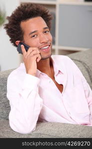 Young man making a call at home
