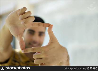 Young man making a finger frame