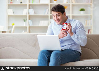 Young man making marriage proposal over internet laptop