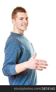 Young man making welcome invitating hand sign gesture or giving palm for handshake. Studio shot isolated